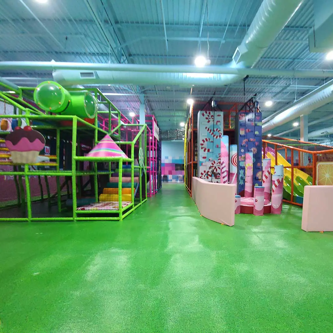 Main indoor playground structure at Candeeland Humble with colorful climbing and slide play.