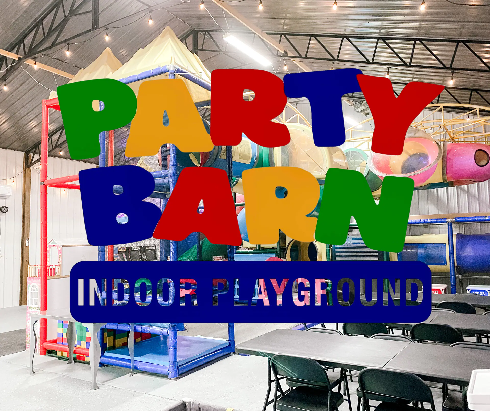 Party tables set beside the indoor play structure at Party Barn.