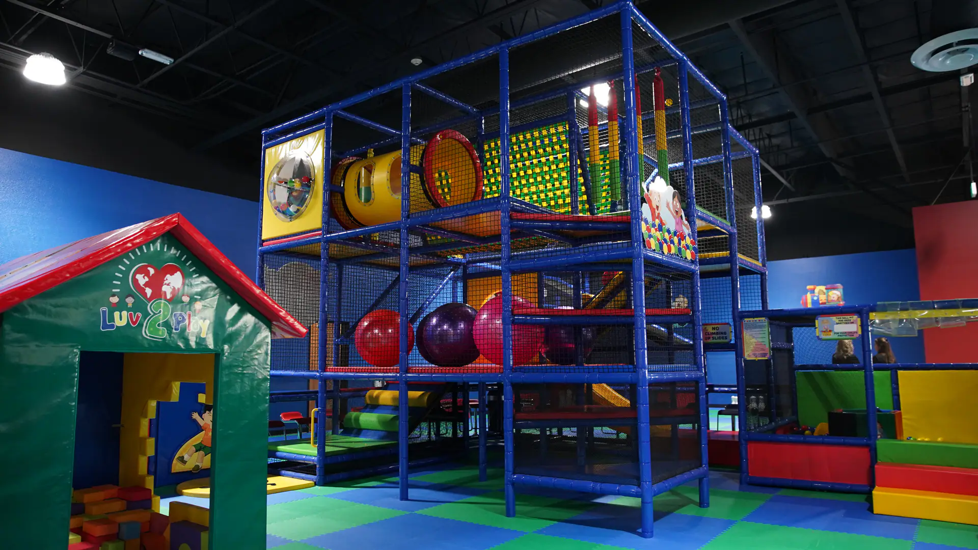 Open play floor with colorful equipment at Luv 2 Play Riverside.