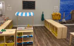 Young children using the play room at Little Milestones