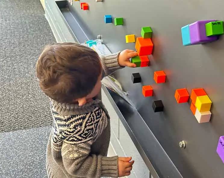 Sensory-style play wall and activity area at Playspace at WL.