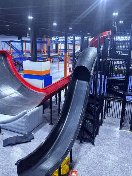 Tall slick slide attraction at Power Up Action Park.