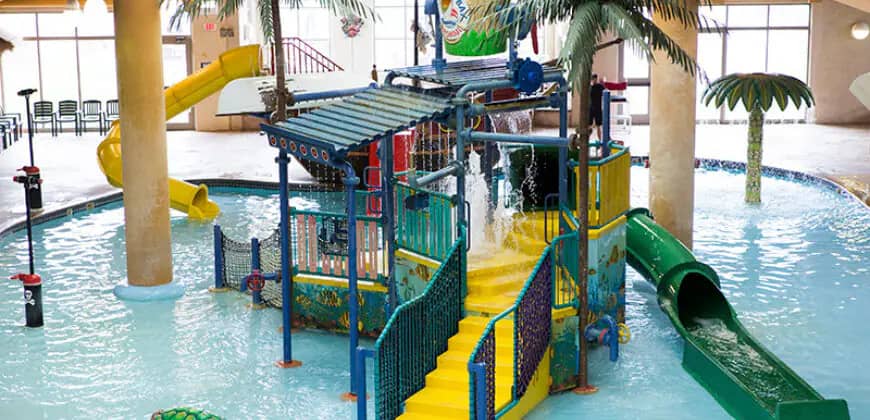 Indoor water play structure with slides and shallow splash area at Boji Splash.