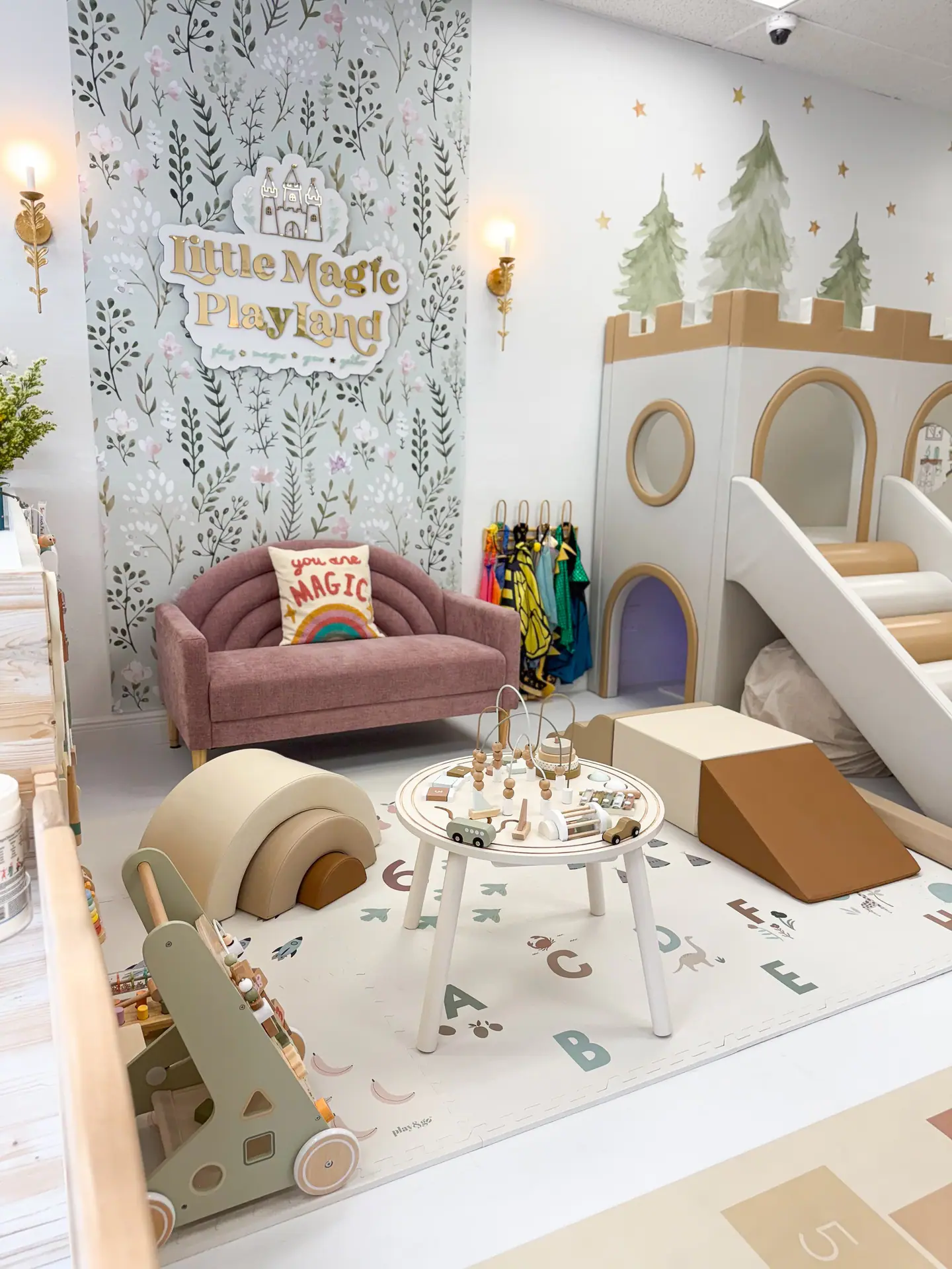 Calm toddler play corner at Little Magic Playland with a small slide and soft play pieces.