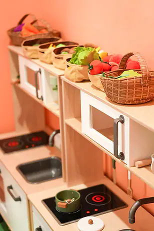 Pretend-play kitchen area at Happy Kidz Play Cafe.