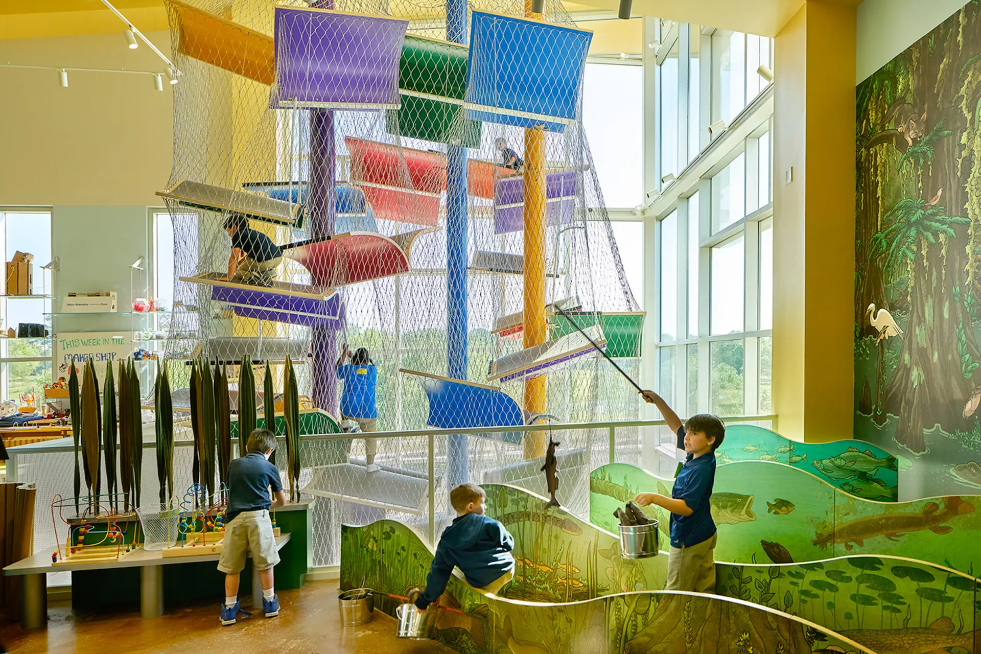 Children playing near the climbing and exploration area at Knock Knock Children's Museum.