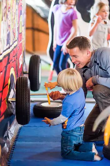 Toddler-friendly play area and activity wall at Holt Stage Hideaway.