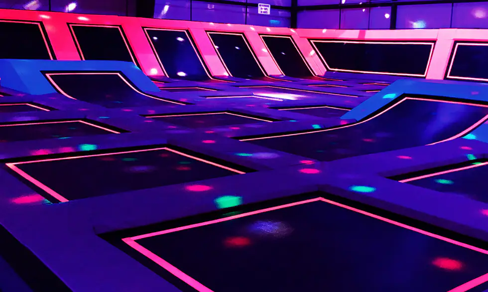 Neon trampoline court at Play Lab Action Park