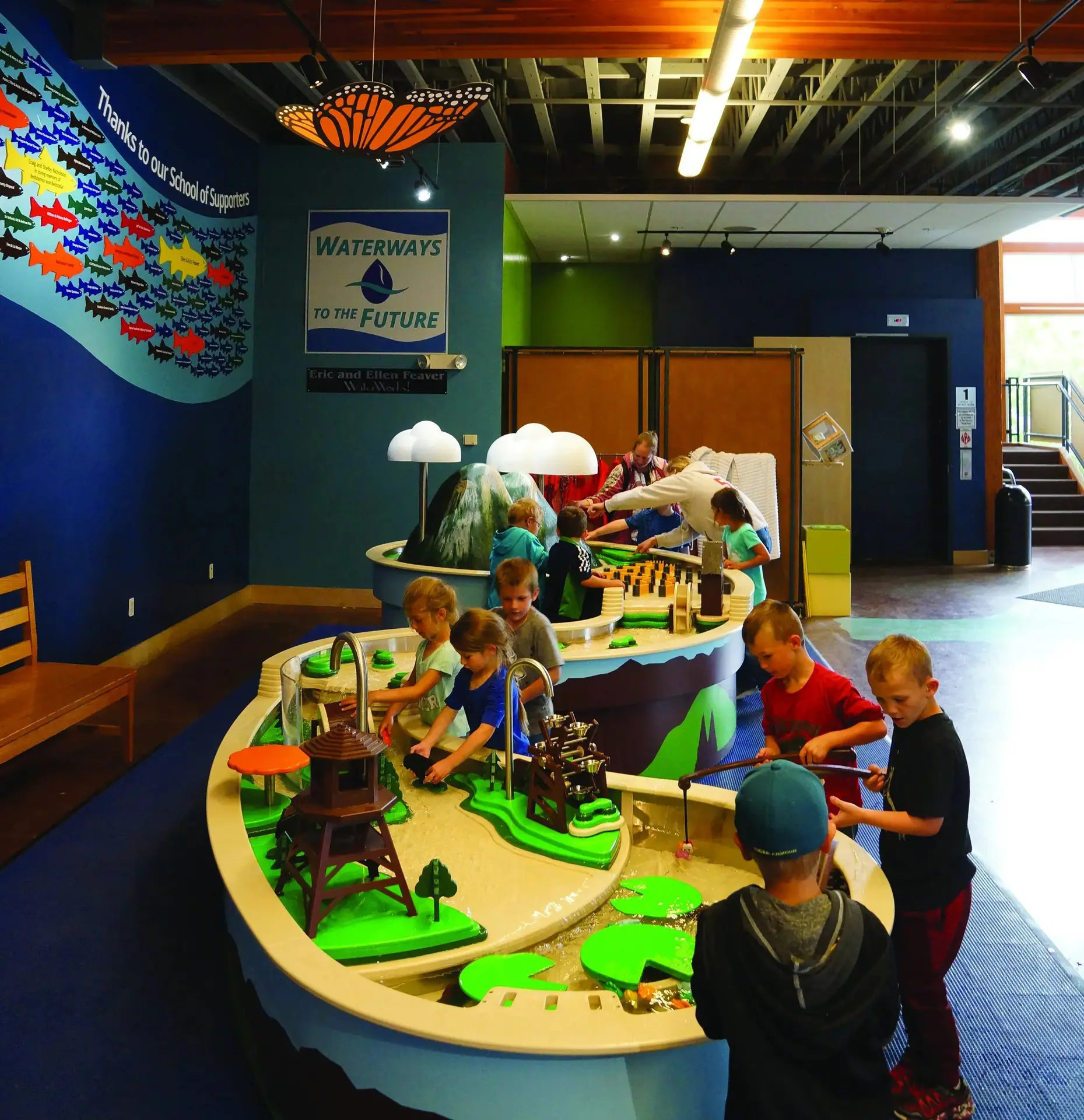 Kids exploring the Waterways to the Future water table at ExplorationWorks.