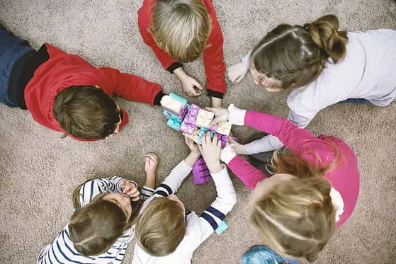 Young children in a group early-learning setting connected to Tot Time programming.