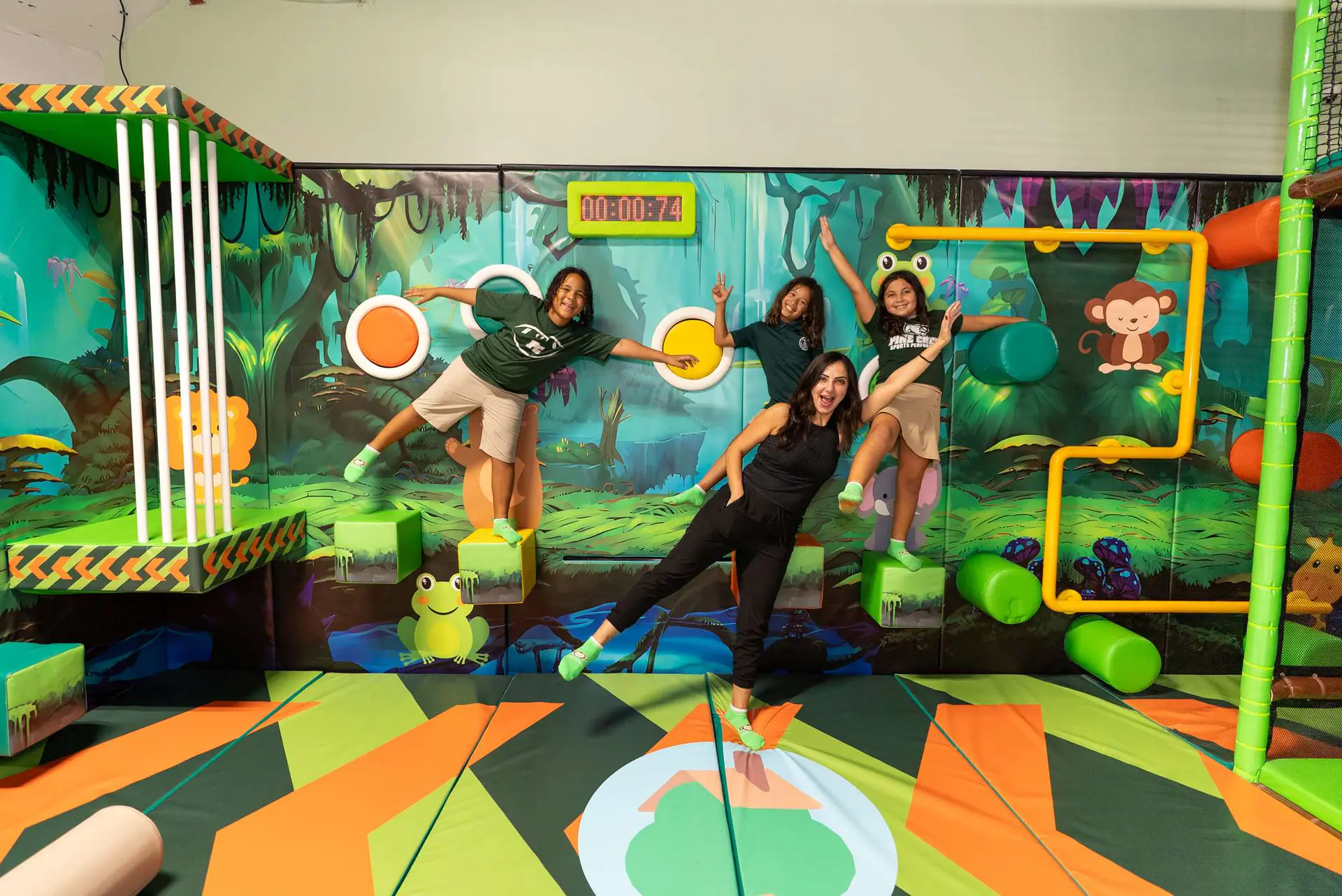 Families and staff inside the main jungle-themed indoor play area.