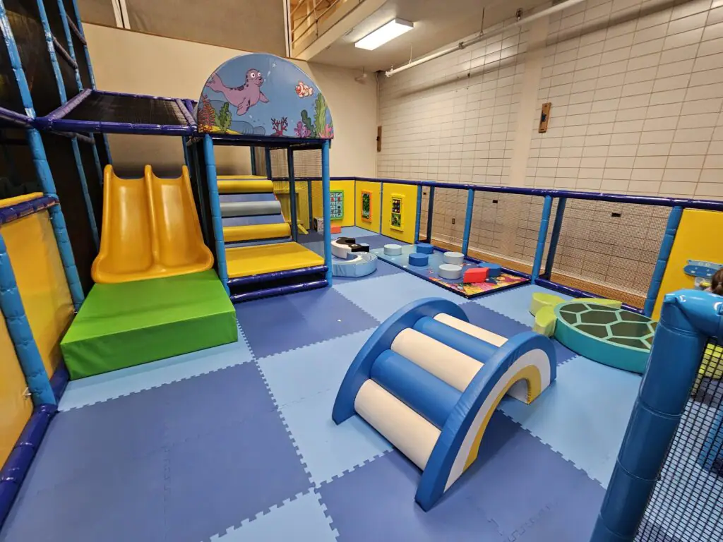 Separate toddler area with low slides and soft play elements at Sheridan County YMCA Playland