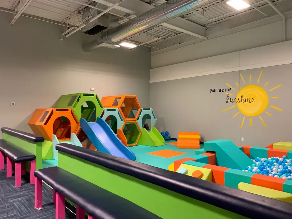 Soft-play toddler area with seating nearby at Up & Away Indoor Play.