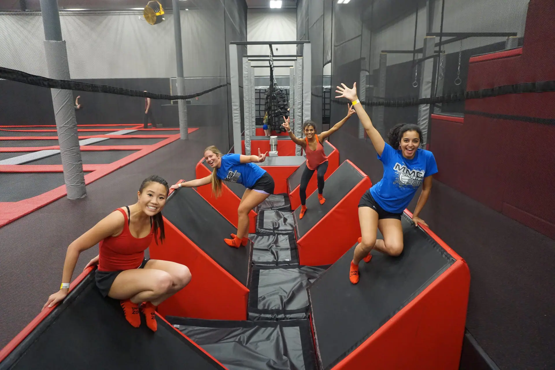 Children using the ninja-style obstacle area at Drop Zone Family Fun Center.