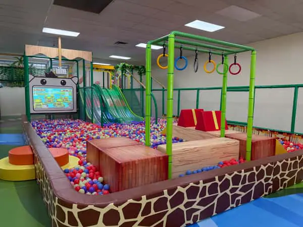 Children playing on colorful indoor attractions at Angel Island Fun Park in Cary.
