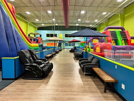 Parent seating area beside the inflatable attractions at Bounce Hopper.