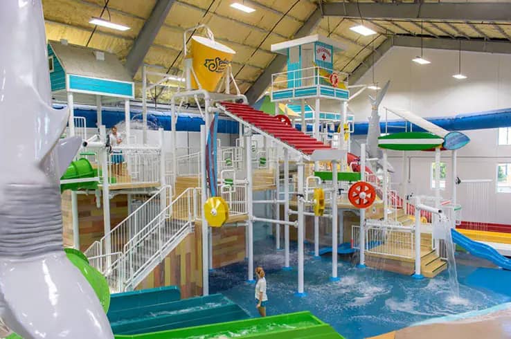 Overview of Splash Shack's indoor water-play structure with slides, spray features, and shallow splash zones in Cedar Park.