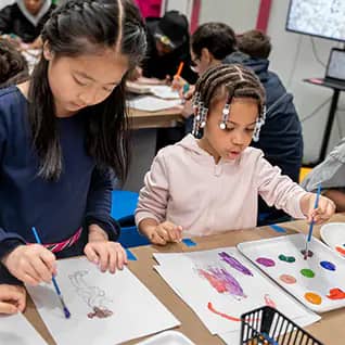 Children participating in a guided art or program activity at CMOM.
