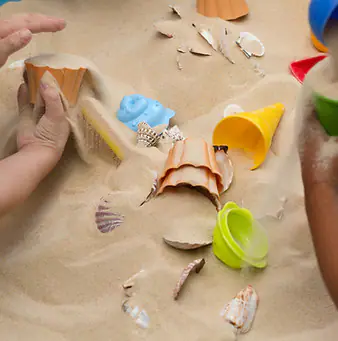 Close-up of the sandPITZ sensory sand area at tinkrLAB.