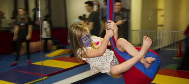 Children and caregivers enjoying adaptive indoor play at We Rock the Spectrum Kid's Gym - Lake Charles.