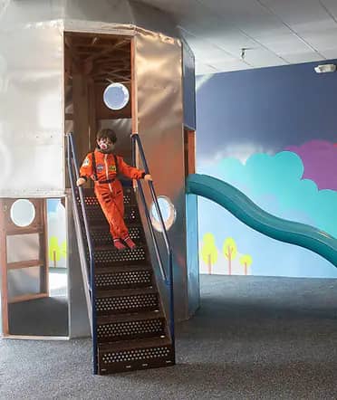 Rocket-themed play feature at Over The Moon Play Space