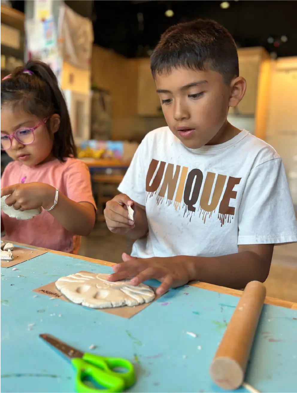 Children shaping clay at a Jackson Hole Children's Museum activity table.
