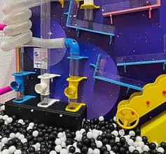 Ball-pit and activity wall inside Bounce N Play Seabrook.