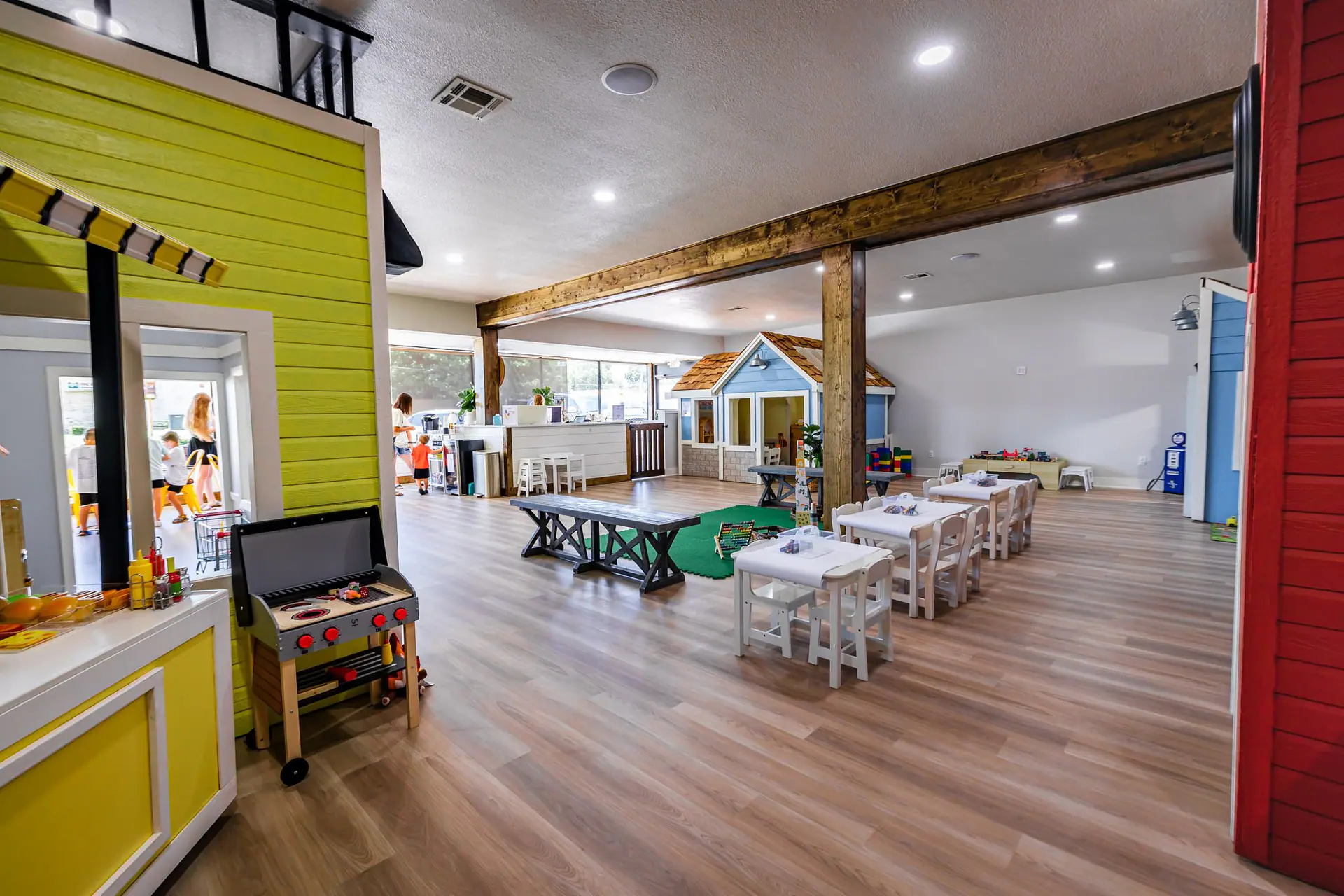 Children exploring imaginative play stations at The Kids’ Playspace.