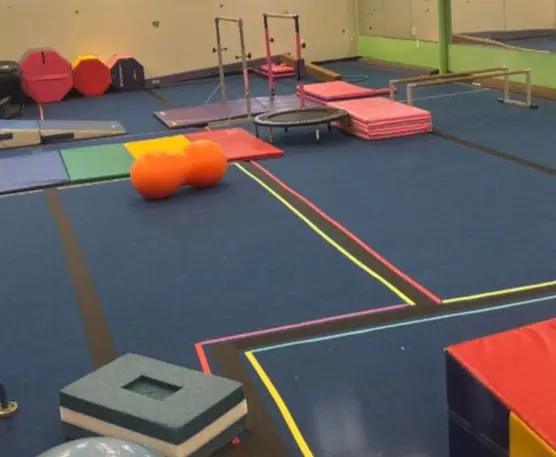 Open gym floor with mats and equipment at Fun Factory.