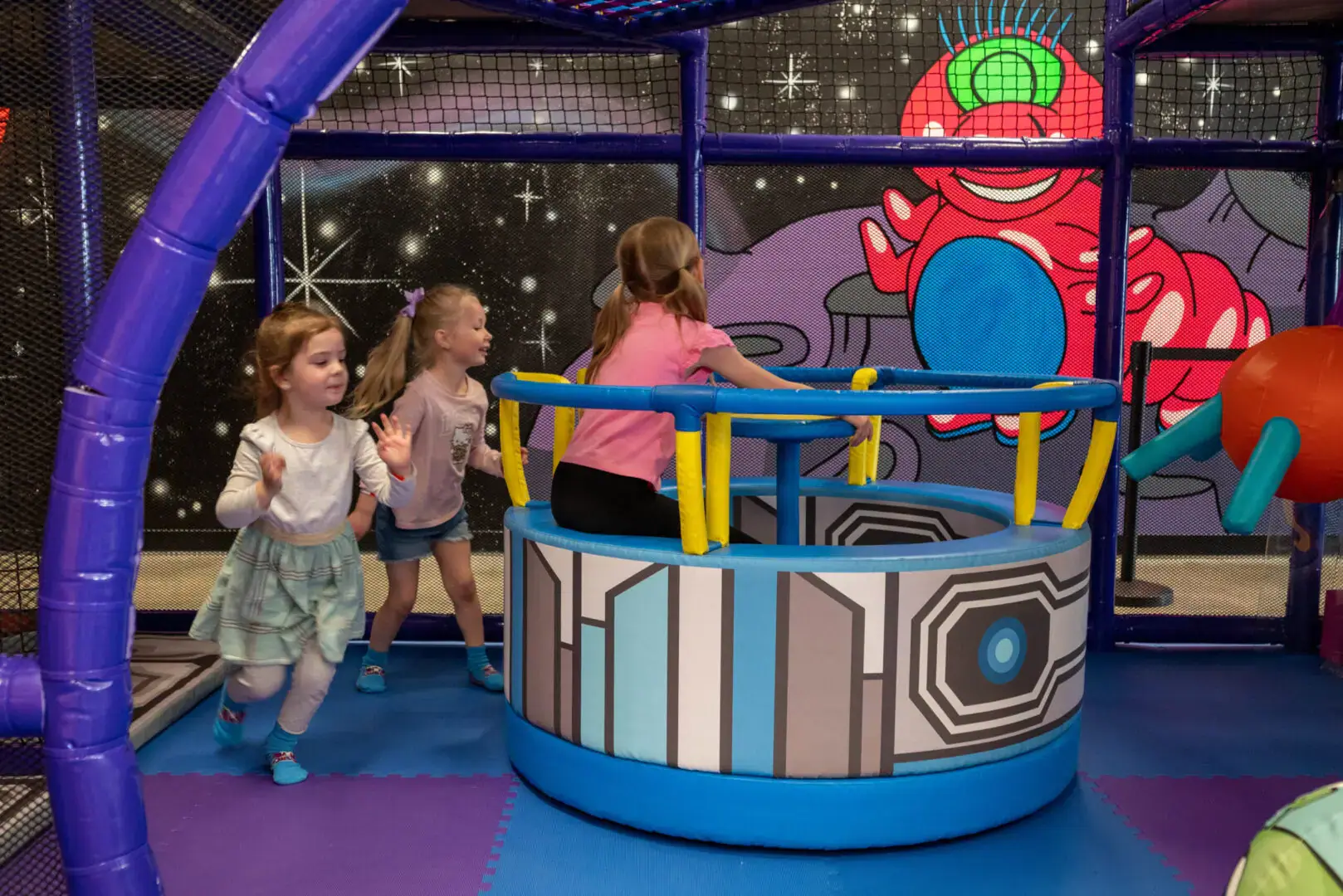 Main play structure inside Club Run & Jump in Olathe with colorful climbing and slide features.