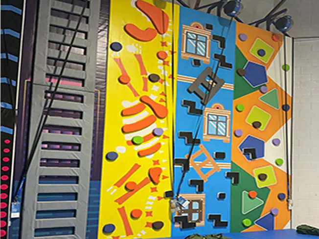 Colorful climbing wall at Funplex Trampoline Park in Hampton.