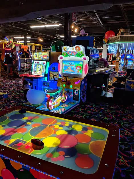 Arcade and interactive floor-game area at FunTime Junction.
