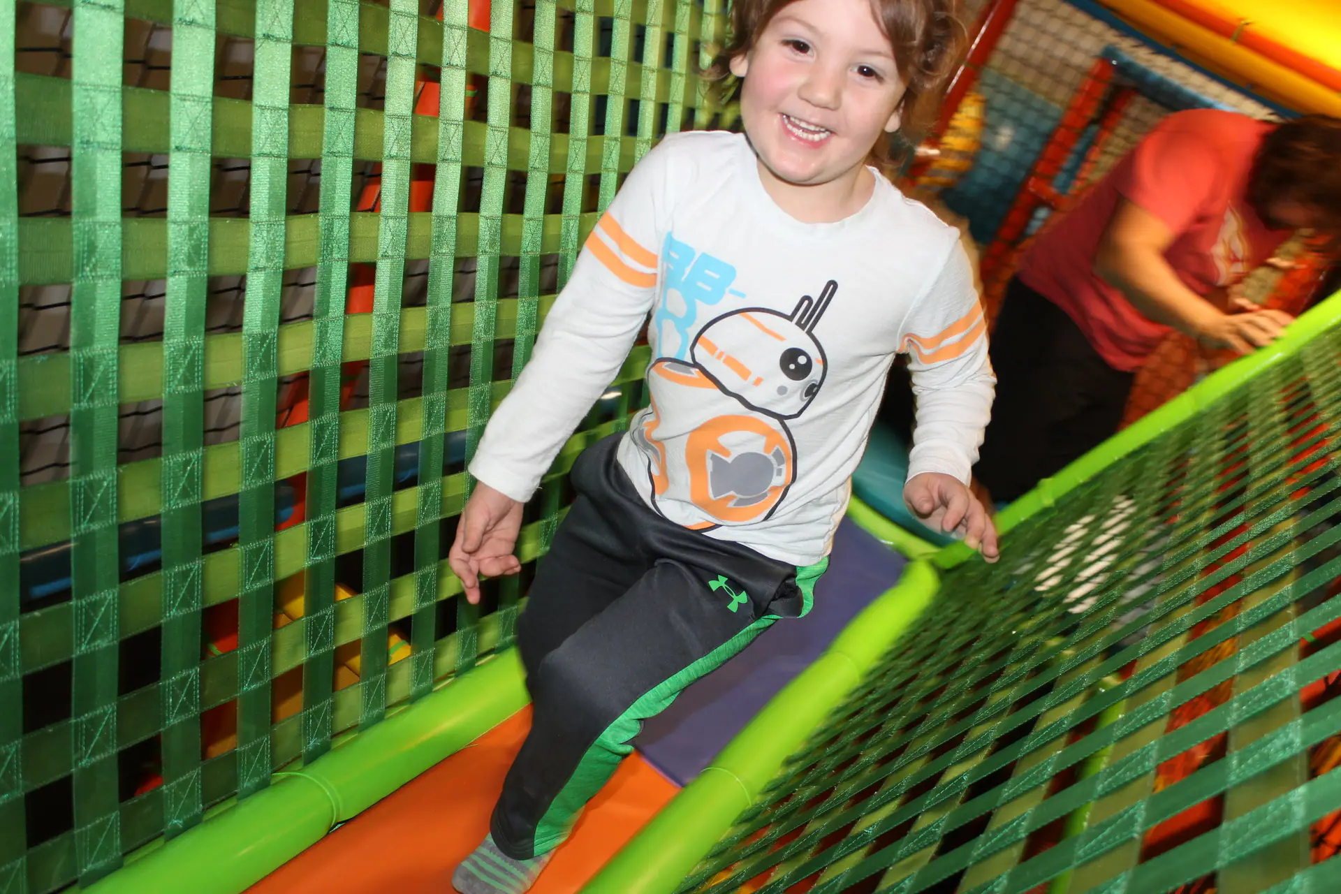 Child climbing inside the play structure at Midland's Playground in Midland