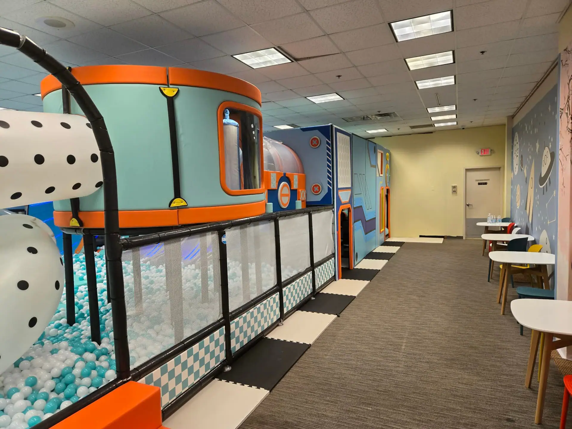 Colorful climbing and sliding play area at ProKids Place.