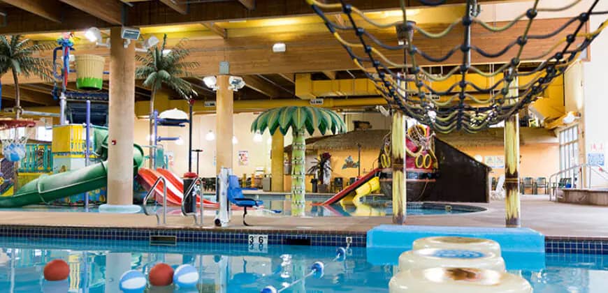 Wide view across the indoor waterpark pool and pirate-themed play area at Boji Splash.