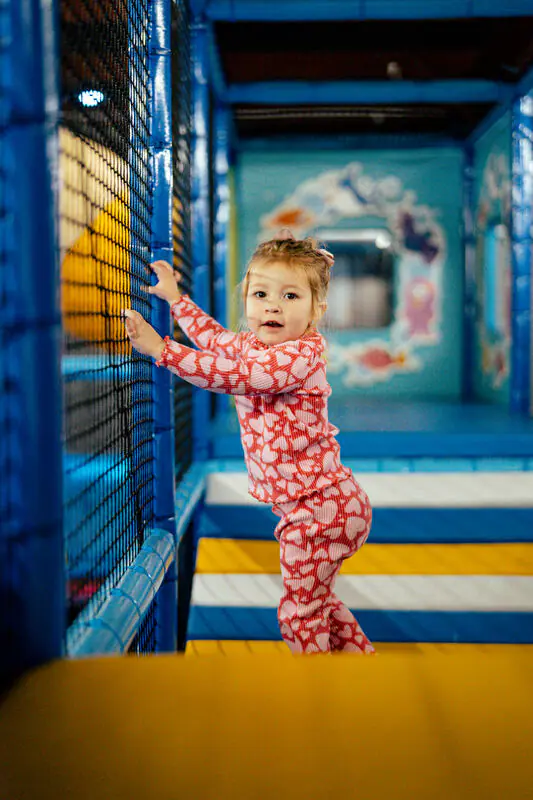Young child inside the play structure at Jumpin' Jacks Zone