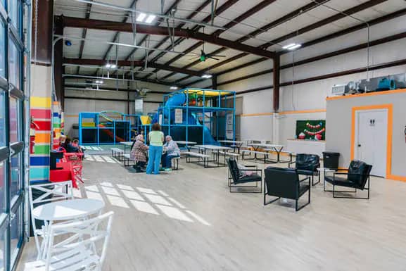 Open seating and play-floor view inside Kid Zone.