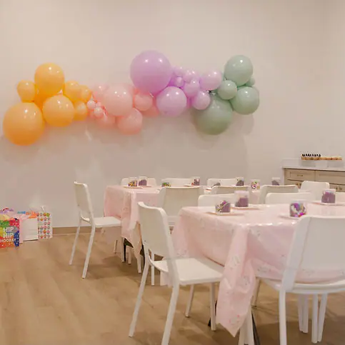 Party room set up with pastel balloons at Dorothy's Playhouse.