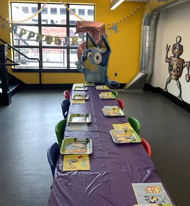 Birthday party table setup inside Wonderfeet Kids' Museum.