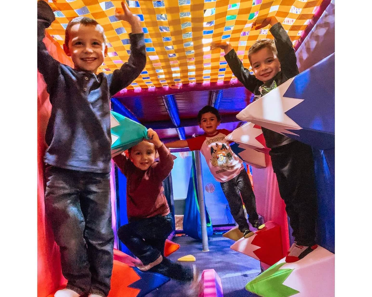 Children playing in the indoor jungle gym at Planet Play.