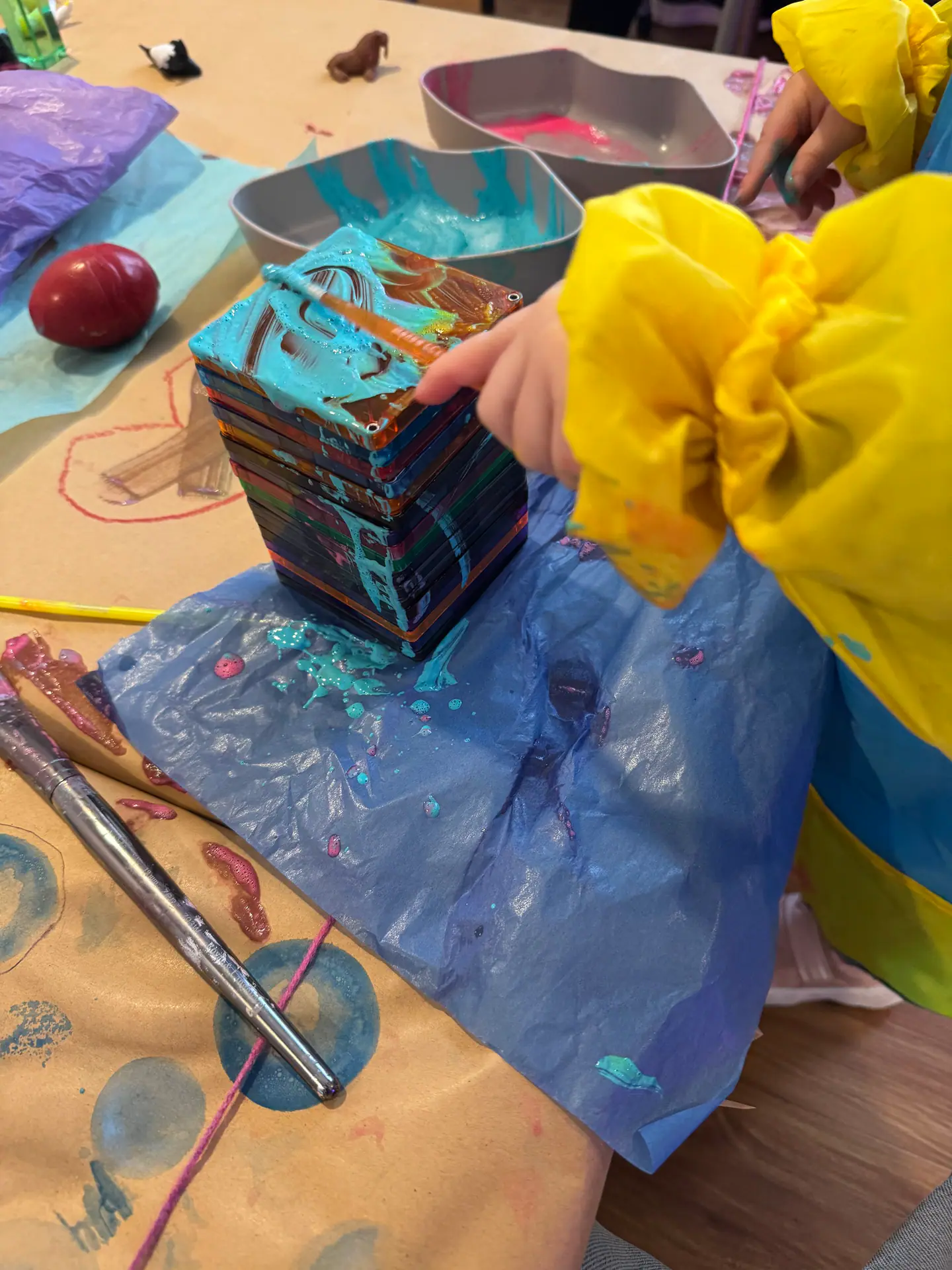 Child exploring process art materials at Blossom Play Space.