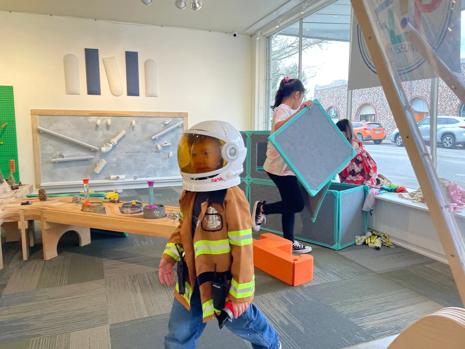 Children exploring a hands-on exhibit area at FLIP Museum in Hillsboro.