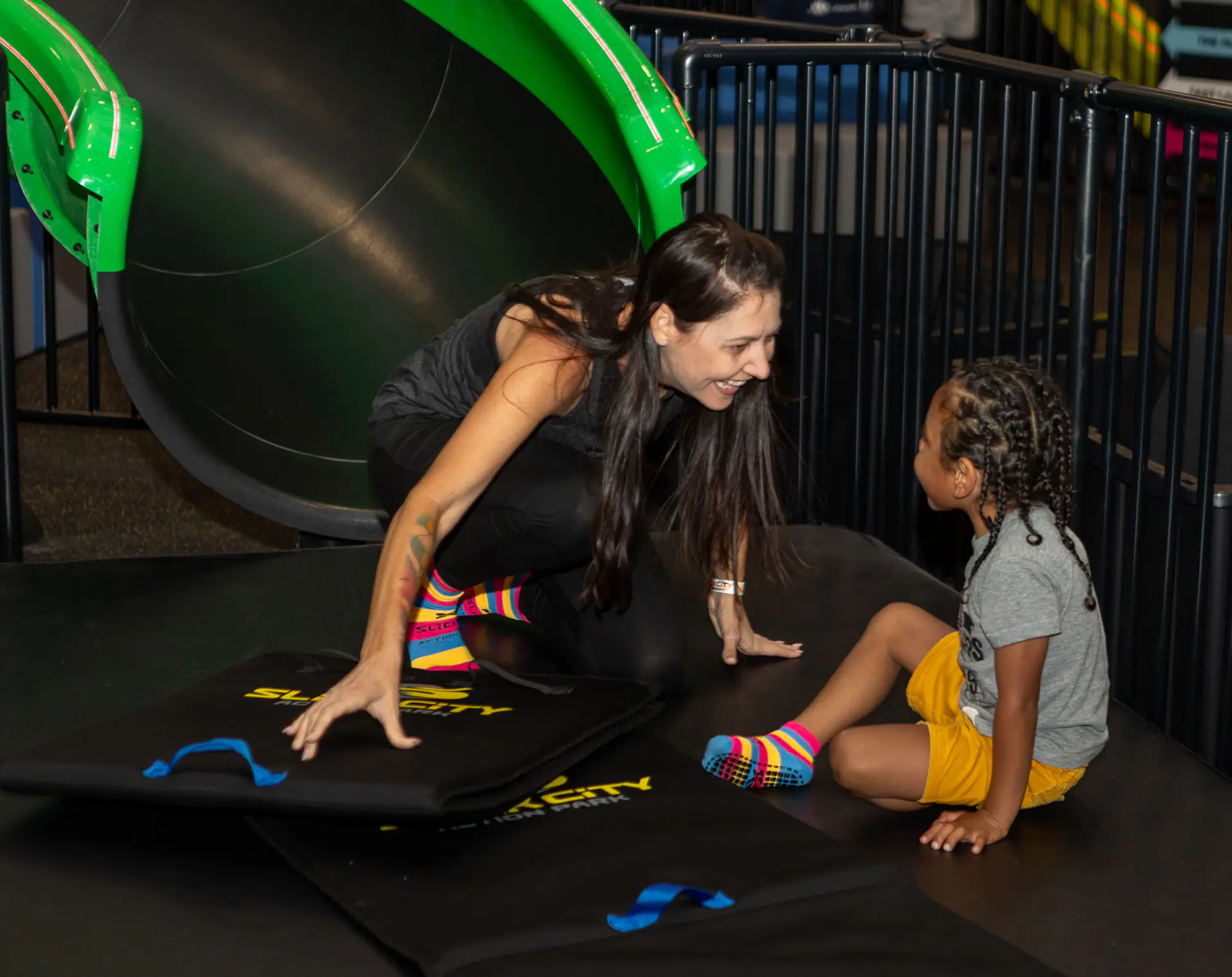 Colorful slide area at Slick City during a sensory-hours promotion.
