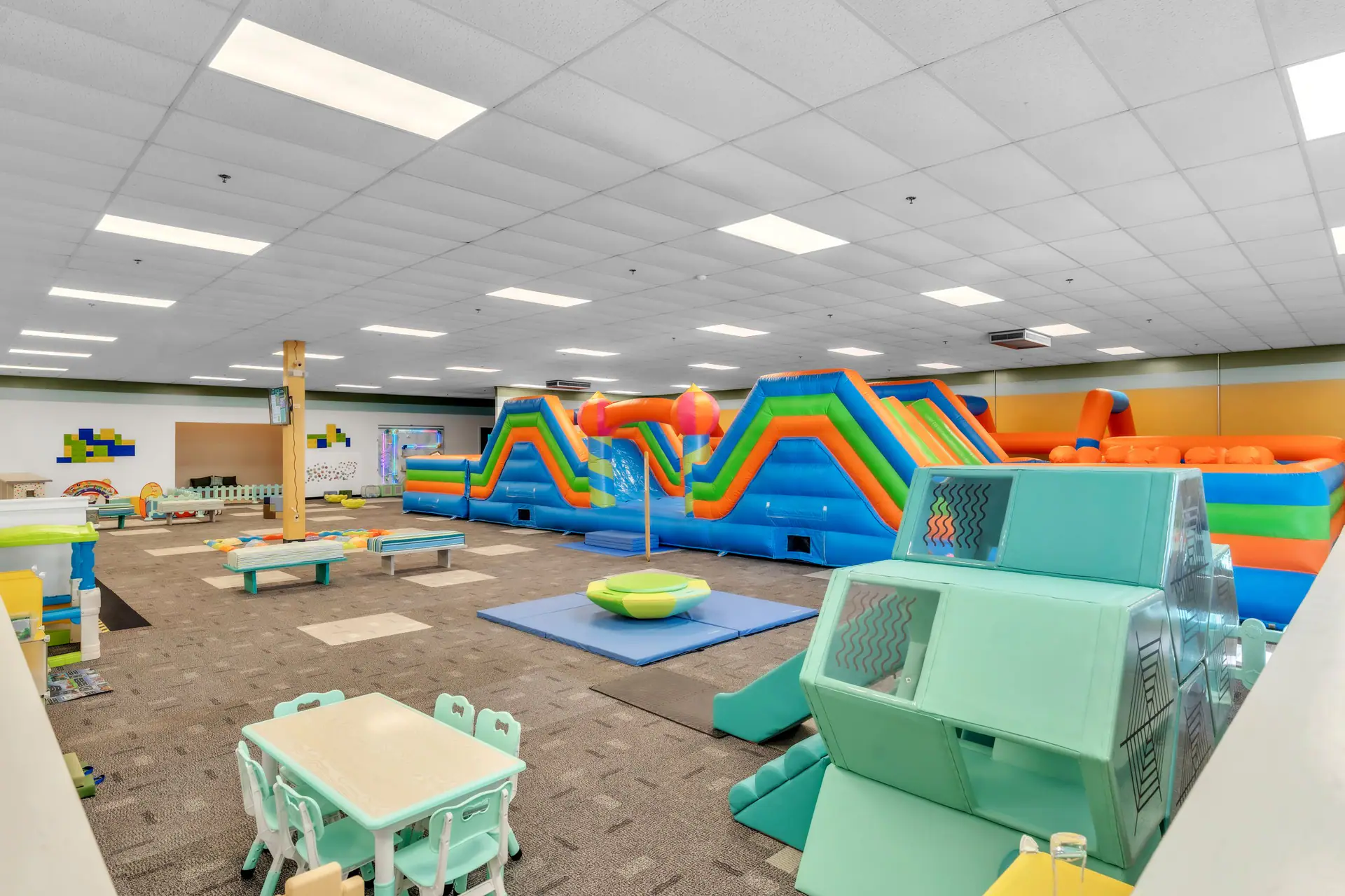 Open play floor and large inflatable obstacle course at Seek & Find Indoor Playscape in Kendallville.