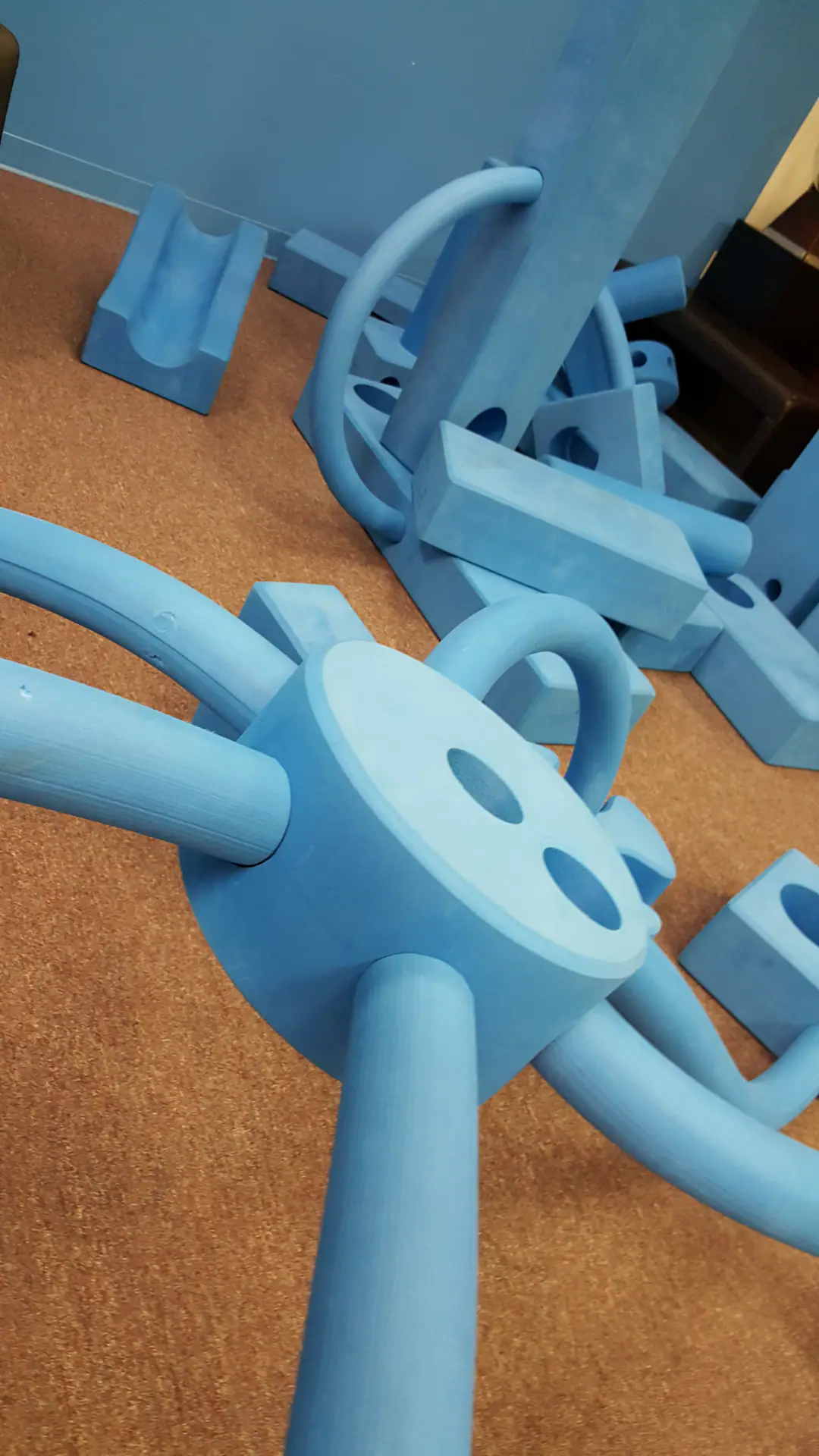 Children building with oversized blue foam blocks at Spark! Imagination and Science Center.