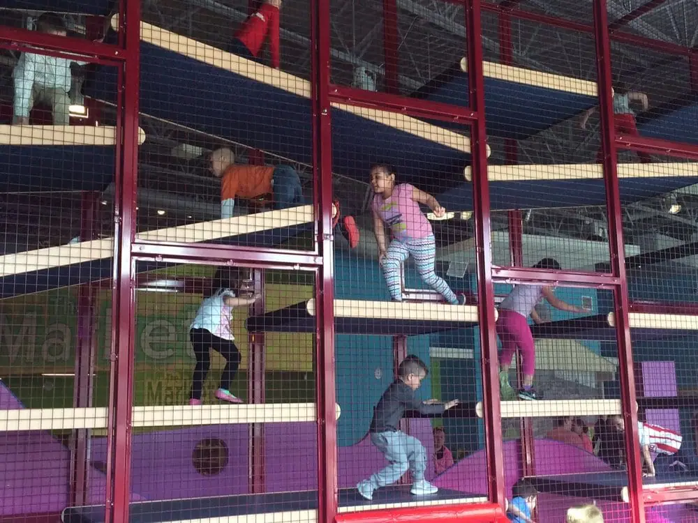 Children climbing inside the large multilevel climber at LaunchPAD Children's Museum.