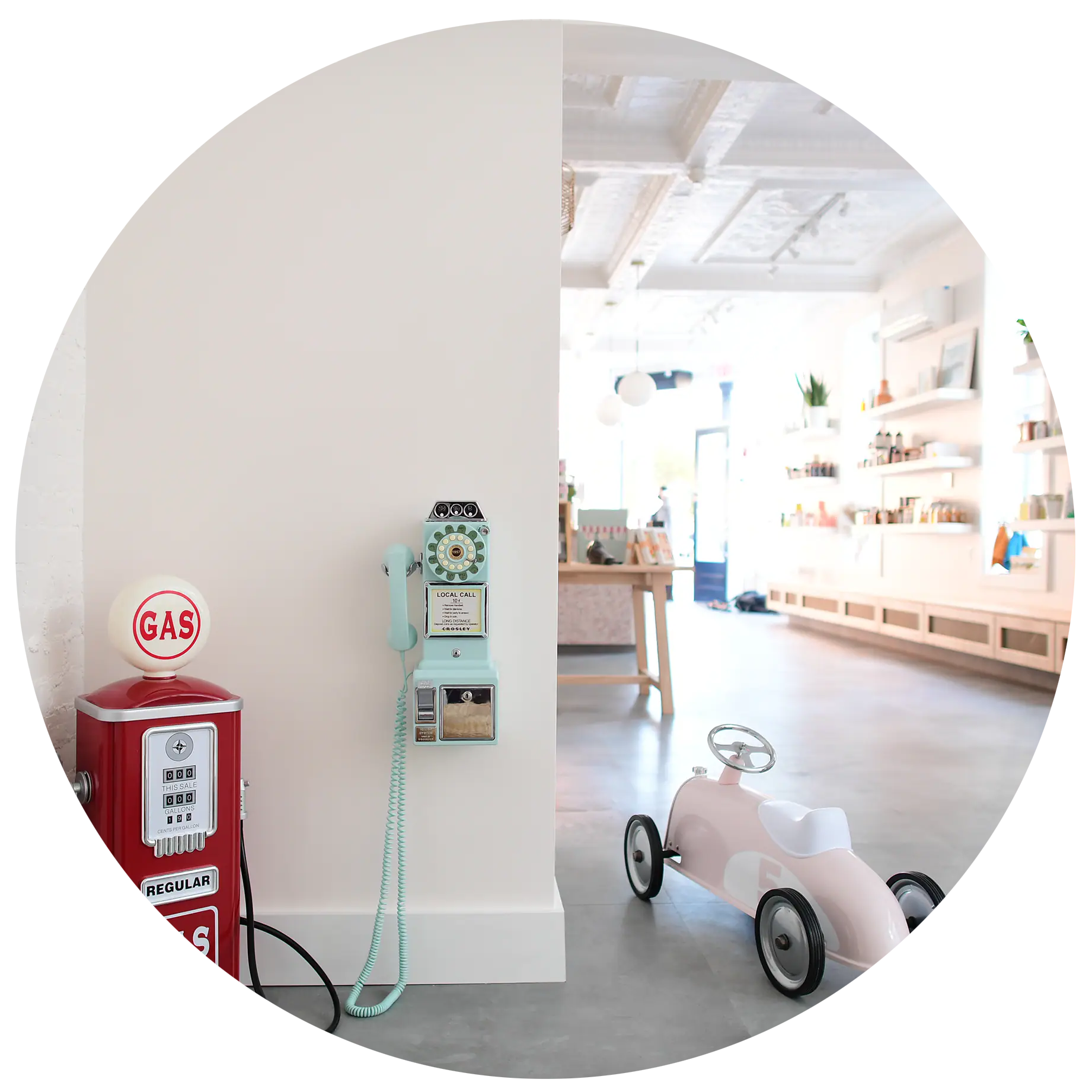 Ride-on toy and market-style corner inside The Hive's bright play-and-café space.