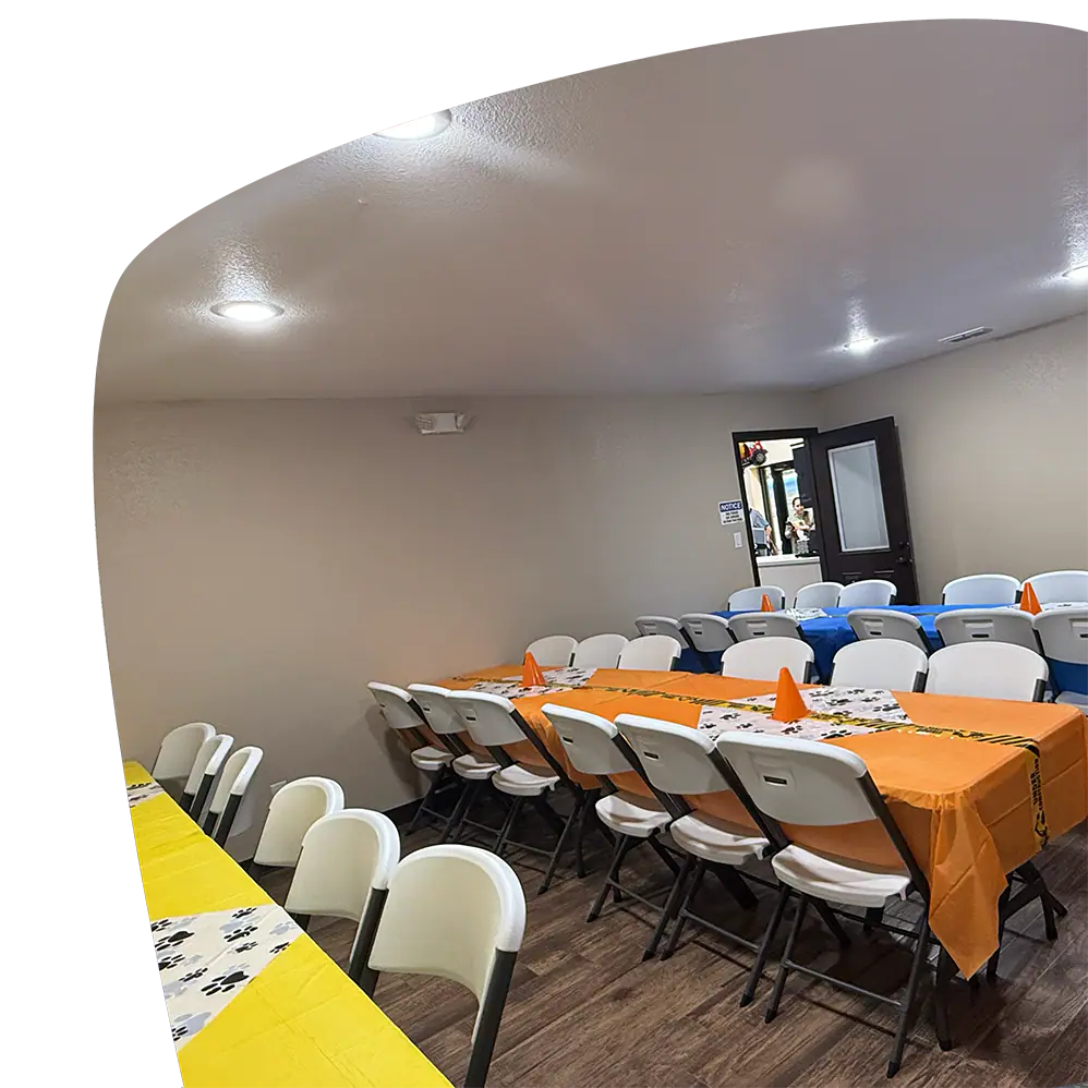 Party room with tables and chairs at Adventure Zone Mineola.
