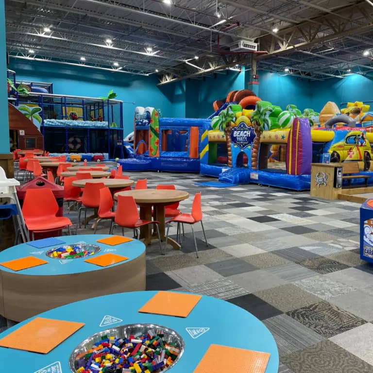 Indoor inflatable play area and family seating at Cowabunga's in Manchester.