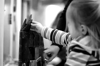 Young child building with magnetic tiles at Creative Adventure Lab.